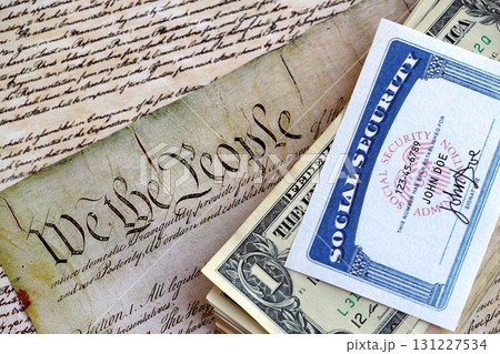SSN Social Security Number card with dollar bills on US Constitution 131227534