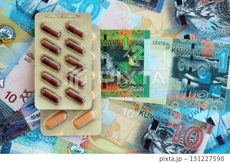 Kuwaiti dinar currency money bills and medicine pills. The concept of medicine and pharmacy Kuwaiti dinar currency money bills and medicine pills. The concept of medicine and pharmacy 131227598