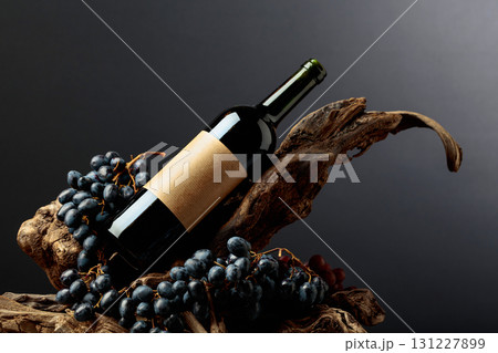 Bottle of red wine with empty label on a old snags. 131227899