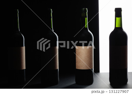 Red wine bottles silhouette over black background. Red wine bottles silhouette over black background. 131227907