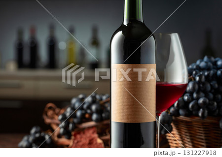 Bottle and glass of red wine with blue grapes. Bottle and glass of red wine with blue grapes. 131227918