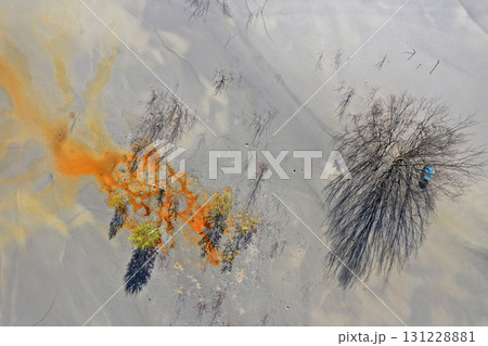 Aerial view of surreal natural patterns of gold cyanide leaching flowing into decanting lake 131228881