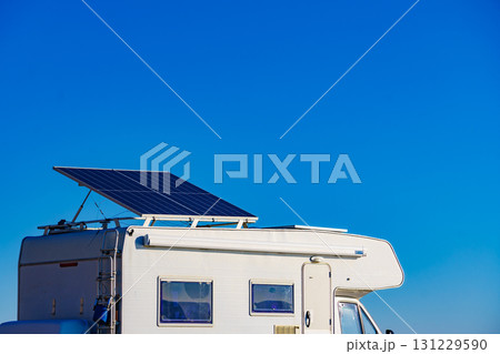 Caravan with tilt solar panels on roof. 131229590