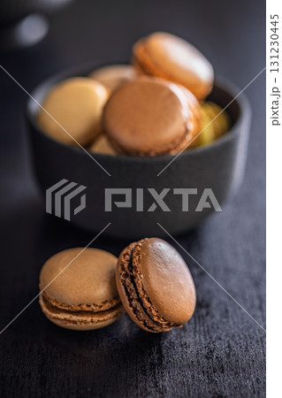 Different flavors of macarons. Colourful macaroons on black table. 131230445