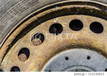 Old rusty car wheel rim closeup 131230623