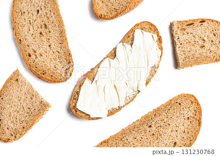 Slices of bread and butter isolated on white background Slices of bread and butter isolated on white background 131230768