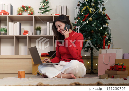 Online Christmas Shopping. Woman on phone and laptop with credit card. 131230795