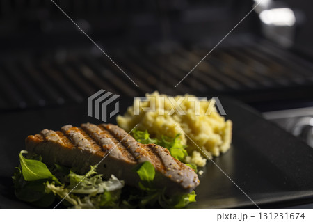 tuna fish steak with couscous and salad tuna fish steak with couscous and salad 131231674