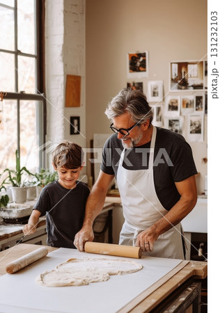 A grandfather and grandson joyfully roll out dough together, creating a heartwarming baking moment filled with family bonding and culinary fun 131232103
