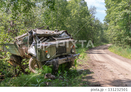 Military logistics. A Soviet-made Russian or Ukrainian military Gaz 66 truck, blown up or blown up, lies overturned near a road in Ukraine. Explosion or ambush 131232501