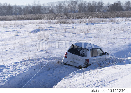 Ice, A car flew off the road into the snow into a ditch on the side of the road, Accidents and road safety in winter, slippery roads An Abandoned Vehicle in a Snowy, Desolate Landscape, 131232504
