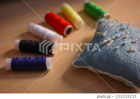 "Colorful sewing threads and pincushion with needles 131233215