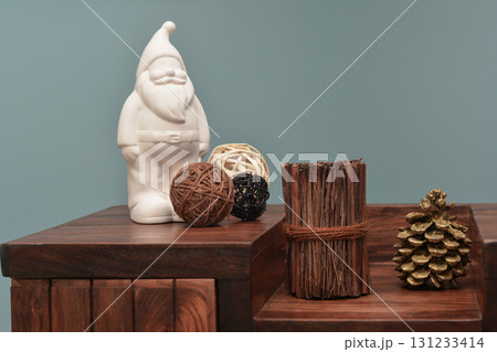 Ceramic santa claus and modern decoration on the wood table Ceramic santa claus and modern decoration on the wood table 131233414