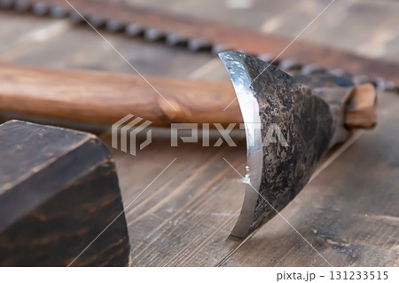 close-up of a sharp ax scraper for removing bark on a table close-up of a sharp ax scraper for removing bark on a table 131233515