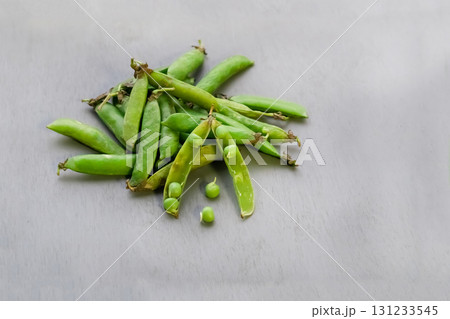 green peas fresh vegetables scattering on gray background 131233545