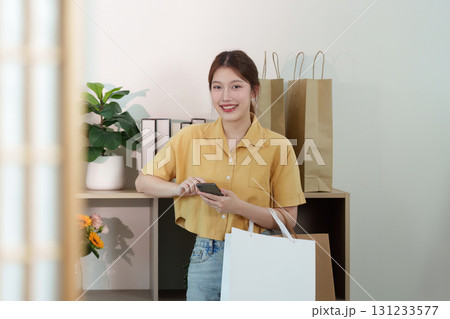Shopping and Digital Engagement. Young woman using smartphone after shopping. Shopping and Digital Engagement. Young woman using smartphone after shopping. 131233577