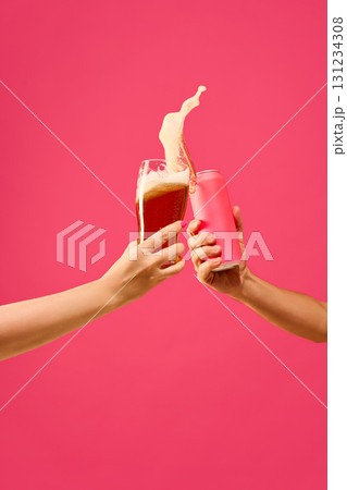 Splash of beer glass and mockup can collision on pink background Splash of beer glass and mockup can collision on pink background 131234308