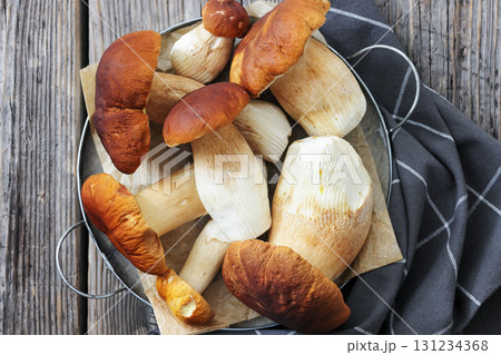 wild porcini mushrooms, ceps on a round metal tray 131234368