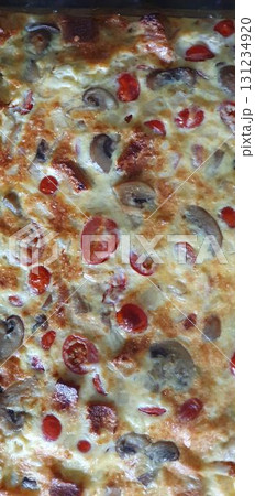 Homemade tomato and mushroom frittata closeup, fresh from oven. Mobile photography, real phone snapshot 131234920