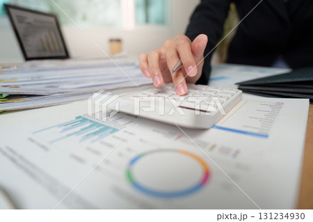 Financial Analysis. Professional using calculator for budget planning and data evaluation. 131234930