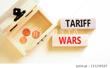 Trade tariff wars symbol. Concept word Tariff wars on beautiful wooden blocks. Beautiful white paper background. Beautiful wooden chest with coins. Business trade tariff wars concept. Copy space. Trade tariff wars symbol. Concept word Tariff wars on beautiful wooden blocks. Beautiful white paper background. Beautiful wooden chest with coins. Business trade tariff wars concept. Copy space. 131236587