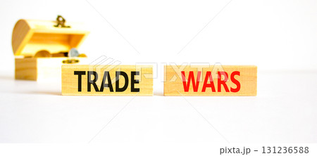 Trade wars symbol. Concept word Trade wars on beautiful wooden blocks. Beautiful white paper background. Beautiful wooden chest with coins. Business trade wars concept. Copy space. 131236588