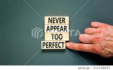 Never appear too perfect symbol. Concept words Never appear too perfect on beautiful wooden blocks. Beautiful grey background. Businessman hand. Business never appear too perfect concept. Copy space. 131236655