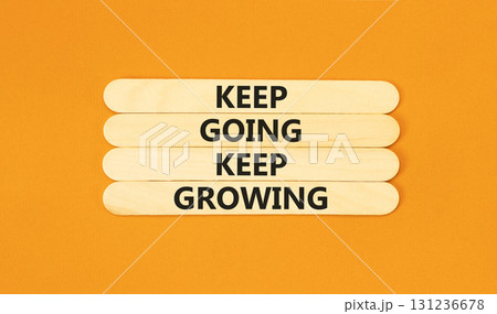 Keep going and growing symbol. Concept words phrase Keep going keep growing on beautiful wooden stick. Beautiful orange paper background. Business Keep going and growing concept. Copy space. 131236678