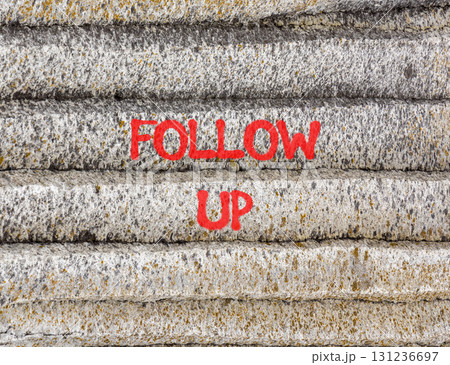 Follow up symbol. Concept word Follow up on beautiful grey mountain wall. Beautiful grey mountain wall background. Business follow up concept. Copy space. 131236697