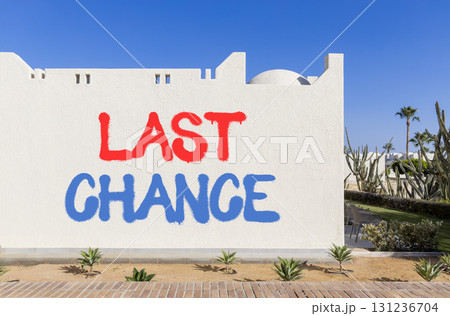 Last chance symbol. Concept word Last chance on beautiful white wall. Beautiful blue sky background. Business last chance concept. Copy space. Last chance symbol. Concept word Last chance on beautiful white wall. Beautiful blue sky background. Business last chance concept. Copy space. 131236704