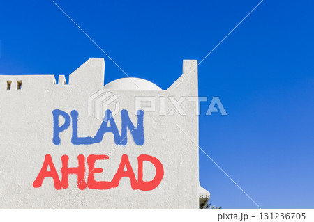 Plan ahead symbol. Concept word Plan ahead on beautiful white wall. Beautiful blue sky background. Business plan ahead concept. Copy space. Plan ahead symbol. Concept word Plan ahead on beautiful white wall. Beautiful blue sky background. Business plan ahead concept. Copy space. 131236705