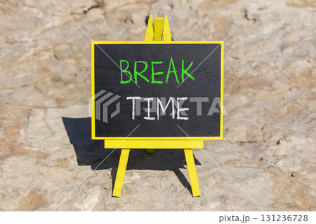 Break time symbol. Concept word Break time on beautiful black blackboard. Beautiful stone background. Black blackboard. Business break time concept. Copy space. Break time symbol. Concept word Break time on beautiful black blackboard. Beautiful stone background. Black blackboard. Business break time concept. Copy space. 131236728