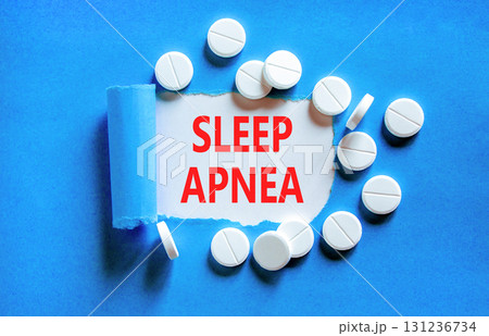 Sleep apnea symbol. Concept words Sleep apnea on beautiful white paper. White pills tablets. Beautiful blue background. Medical healthy lifestyle sleep apnea concept. Sleep apnea symbol. Concept words Sleep apnea on beautiful white paper. White pills tablets. Beautiful blue background. Medical healthy lifestyle sleep apnea concept. 131236734