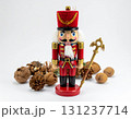 Red Nutcracker Figurine with Decorative Nuts on White Background 131237714