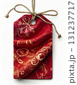 Festive Red and Gold Gift Tag with Twine String on White Background for Holiday Celebration 131237717
