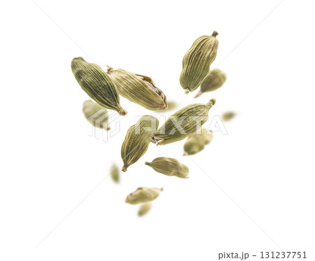 Cardamom pods levitate on a white background Cardamom pods levitate on a white background 131237751