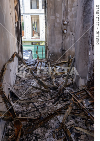 War. The aftermath of Russian airstrikes on a peaceful Ukrainian city. A hospital and a recreation center were destroyed. Fire damaged interior with charred beams, broken roof, and scattered debris. War. The aftermath of Russian airstrikes on a peaceful Ukrainian city. A hospital and a recreation center were destroyed. Fire damaged interior with charred beams, broken roof, and scattered debris. 131238810