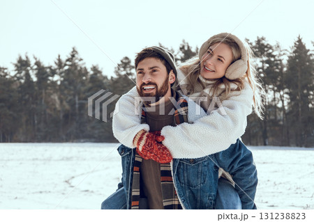 Happy couple spending time together and having fun in a winter forest Happy couple spending time together and having fun in a winter forest 131238823