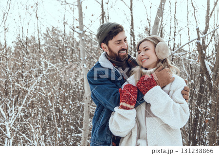 Dark-haired young man hugging his wife and both looking happy and in love 131238866