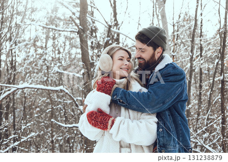 Young people feeling happy and in love while spending time together in a snowy forest Young people feeling happy and in love while spending time together in a snowy forest 131238879