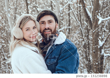 Young people feeling happy and in love while spending time together in a snowy forest Young people feeling happy and in love while spending time together in a snowy forest 131238898