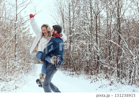 Cute couple enjoying winter time while walking in a forest 131238915