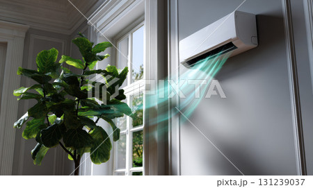 Modern white air conditioner on wall inside comfortable home. unit blowing cool, refreshing air into room next to window with green plant creates calm atmosphere Modern white air conditioner on wall inside comfortable home. unit blowing cool, refreshing air into room next to window with green plant creates calm atmosphere 131239037