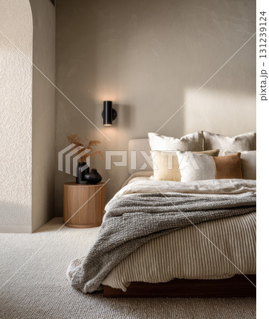 Tranquil, modern bedroom interior featuring minimalist decor. Cozy home furniture and comfortable bed create perfectly serene and restful space for pure relaxation 131239124