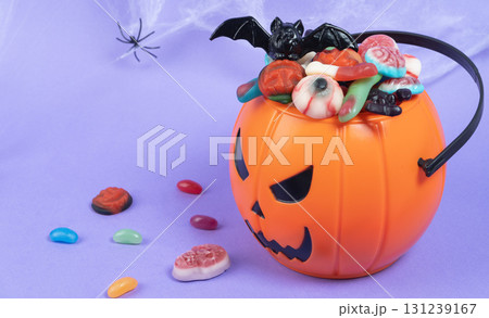 Various halloween sweets on pumpkin basket. Halloween 131239167