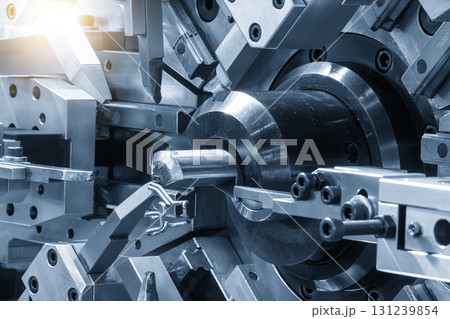 Close up operation of the wire coil spring making machine in the blue tone with lighting effect. 131239854