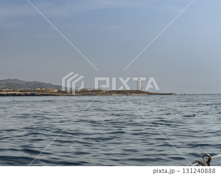 Tarifa island and lighthouse as seen from the straits of Gibraltar Tarifa island and lighthouse as seen from the straits of Gibraltar 131240888