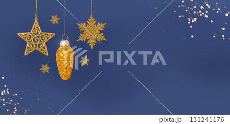 Christmas blue background with Christmas tree decorations with a golden snowflake, star and cone and golden lights with copy space. New Year and Christmas card. Christmas blue background with Christmas tree decorations with a golden snowflake, star and cone and golden lights with copy space. New Year and Christmas card. 131241176