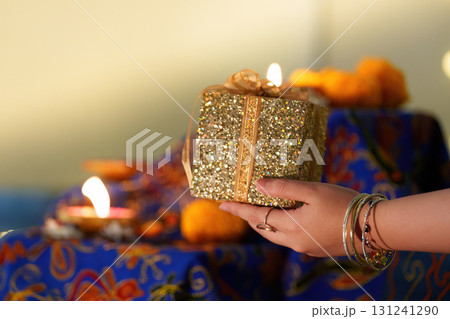 Gift Exchange During Diwali Celebration with Candles Gift Exchange During Diwali Celebration with Candles 131241290