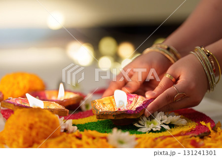 Diwali Candles and Rangoli with Floral Decorations Diwali Candles and Rangoli with Floral Decorations 131241301